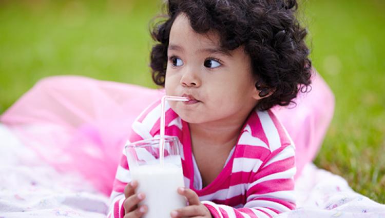 young child drinking milk
