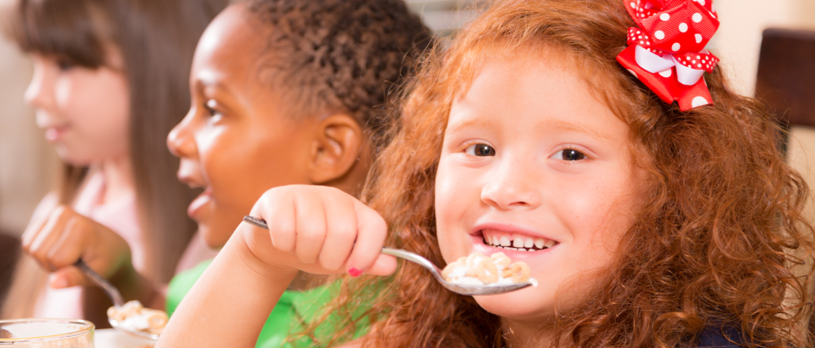 child eating breakfast