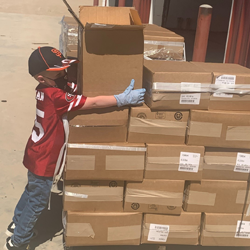 Tyce Diepersloot helping with the donated cheese at the food bank