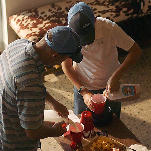 Dairy farmers pouring milk.