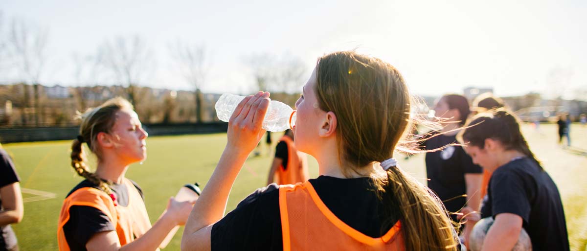 Athletes hydrating on the sidelines