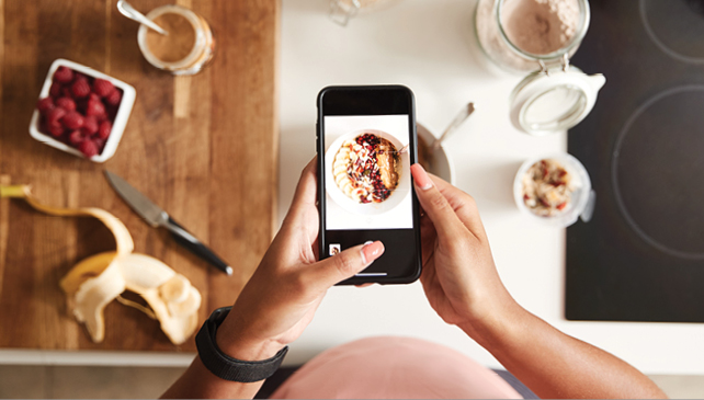 Person taking a picture of meal