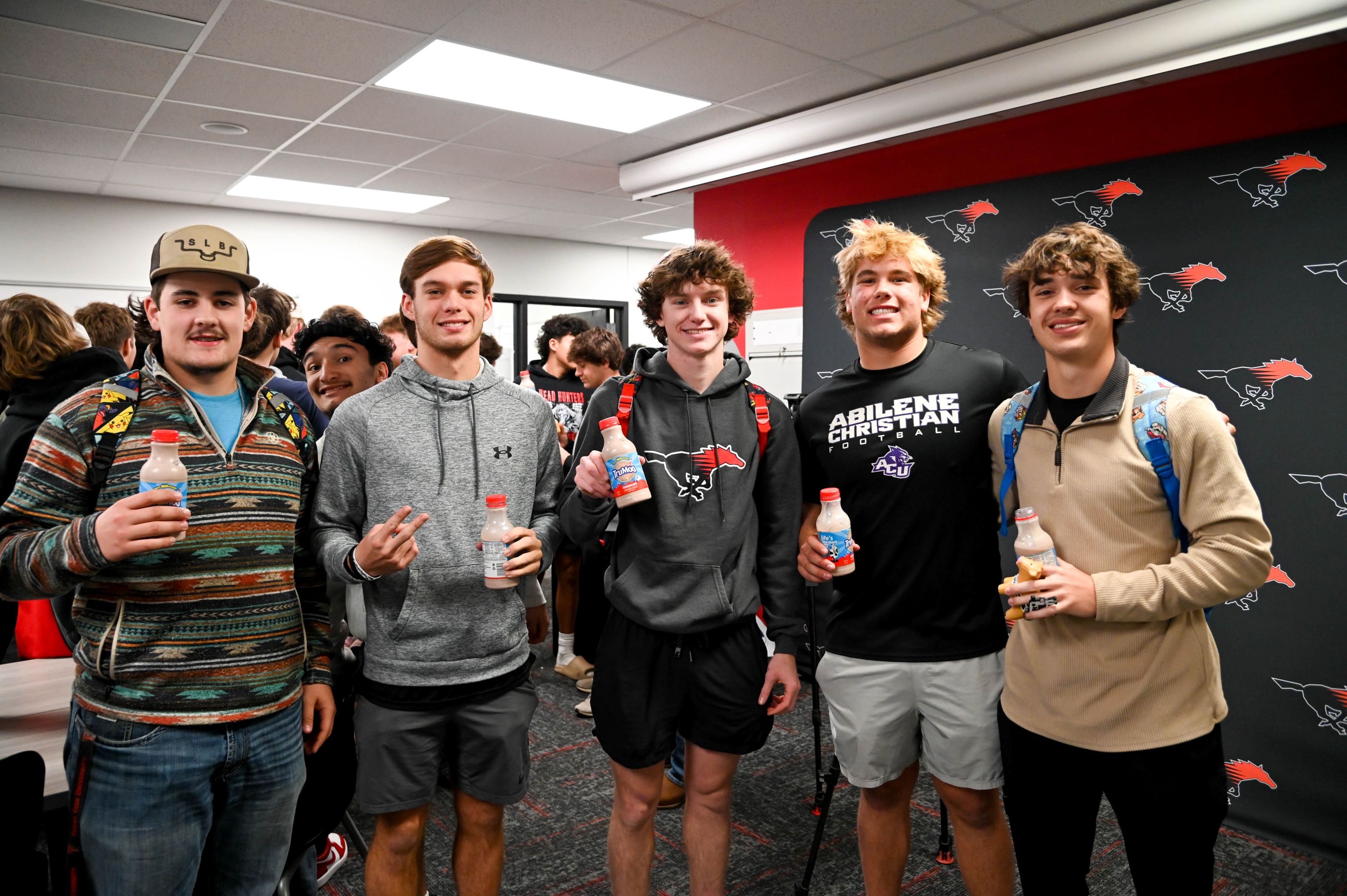 high school student athletes holding chocolate milk