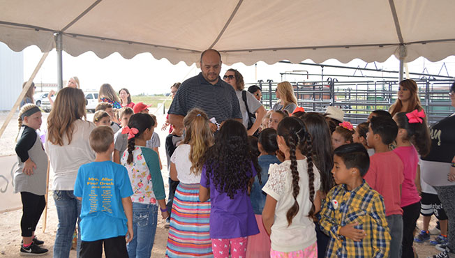 Amezcua talks with a group of students visiting his farm.