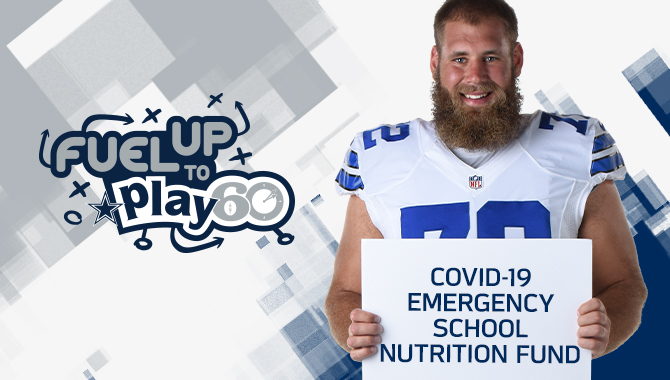 Travis Frederick with a sign that says "COVID-19 Emergency School Nutrition Fund"