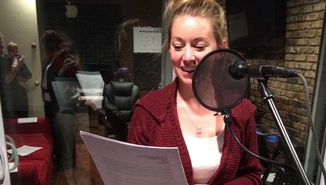 woman at a microphone in a recording studio