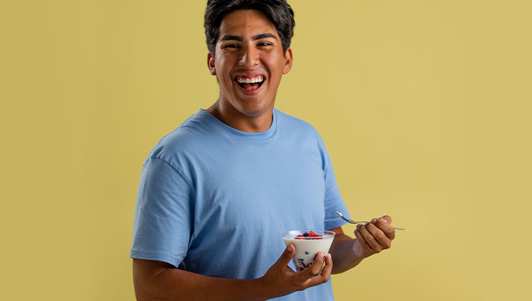 Man eating smoothie.