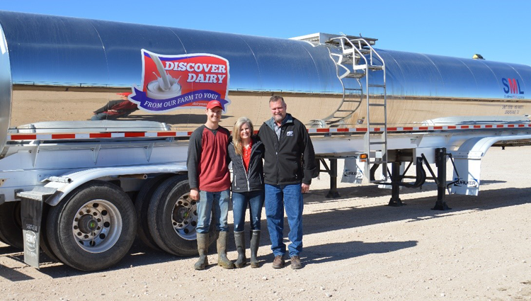 tanker and a family in front of it