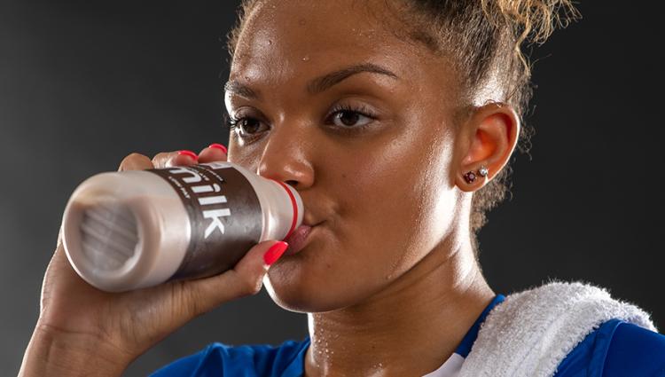 Athlete drinking chocolate milk.