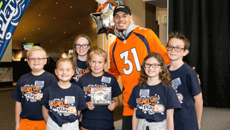 Justin Simmons poses with students at the Fuel Greatness Touchdown Recognition Event