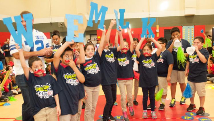 kids posing for a picture with "milk" signs