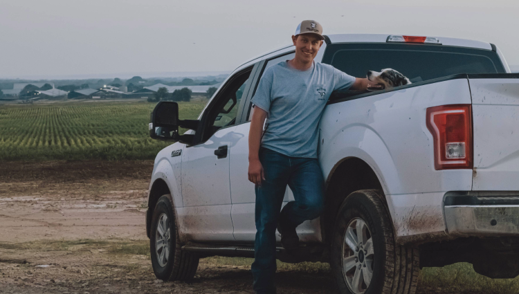 Dairy farmer leaning on his truck