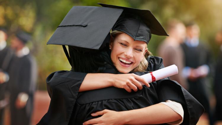 graduates hugging