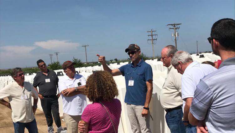 group talking at a dairy farm